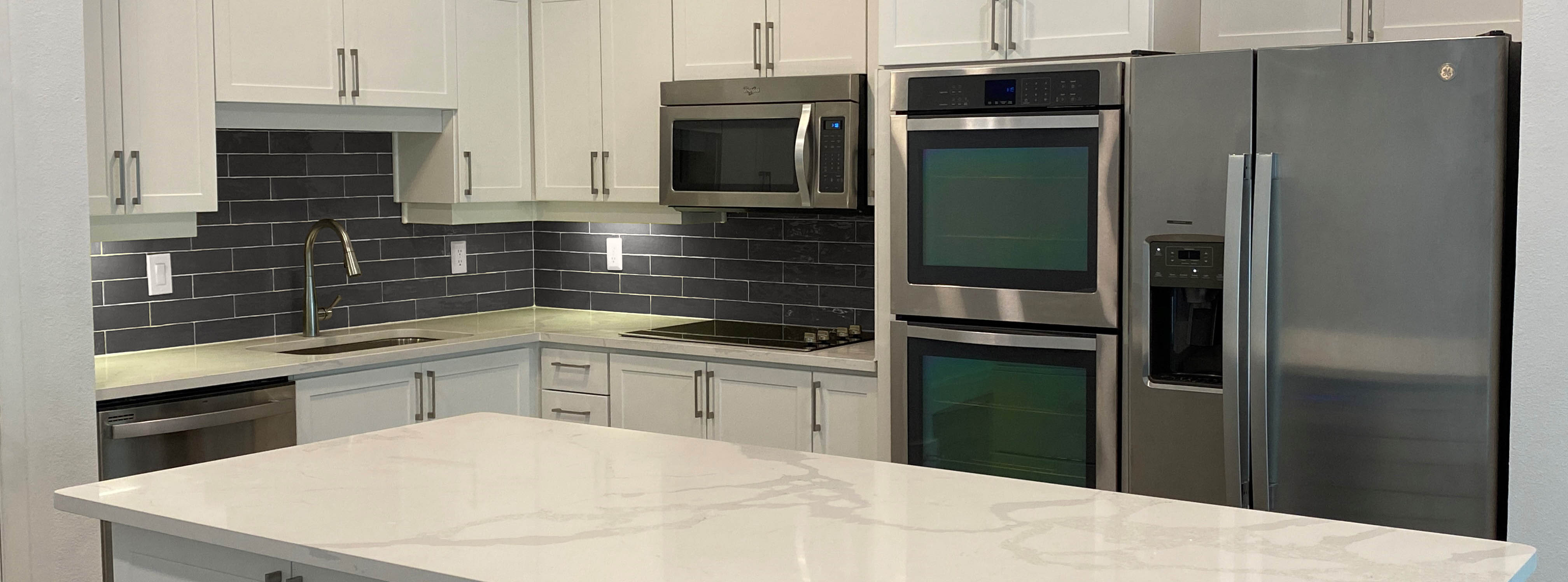 Updated stainless steel appliances, cabinetry, and flooring