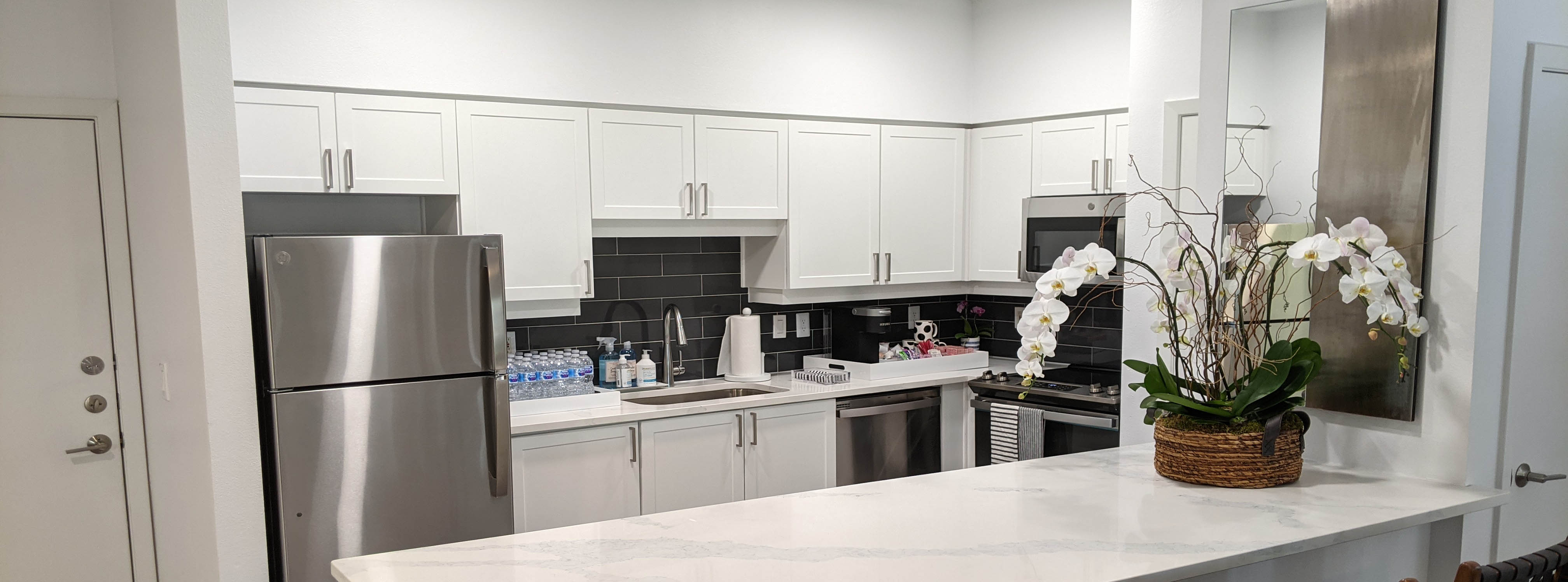Lovely quartz countertops with stainless steel appliances